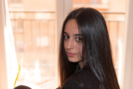 Portrait of a beautiful young brunette woman with long straight hairの写真素材