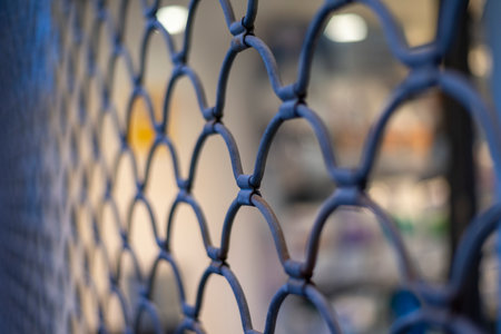 Chain link fence with selective focus. Abstract background and texture for design.の写真素材