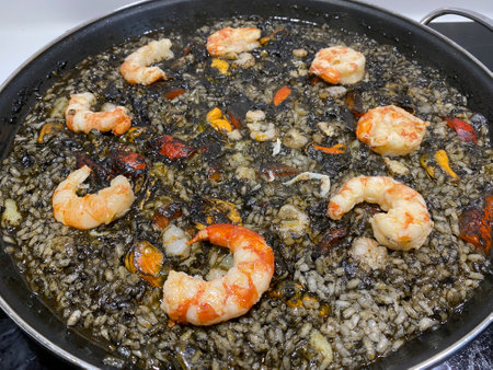 Risotto with shrimps in a pan on a black backgroundの写真素材