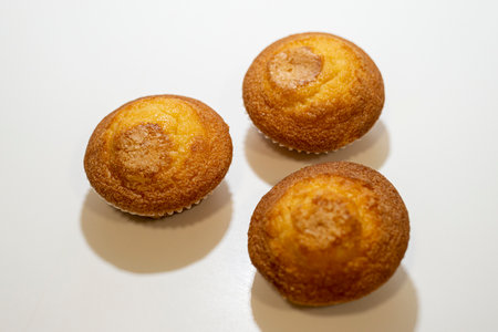 Muffins with sugar on a white background, close-upの写真素材