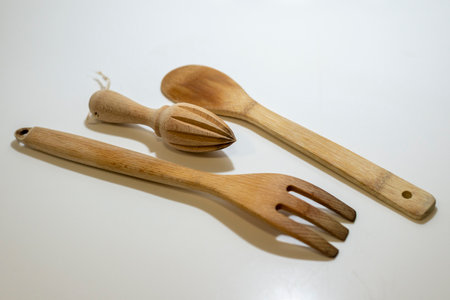 Wooden kitchen utensils on a white background. Shallow depth of field.の写真素材