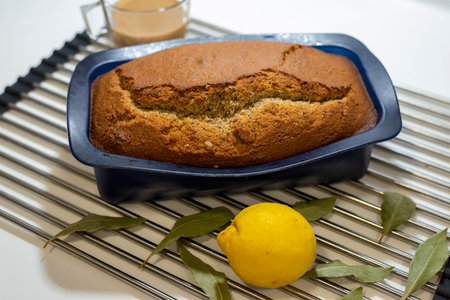 Freshly baked homemade lemon cake with fresh lemons and bay leavesの写真素材