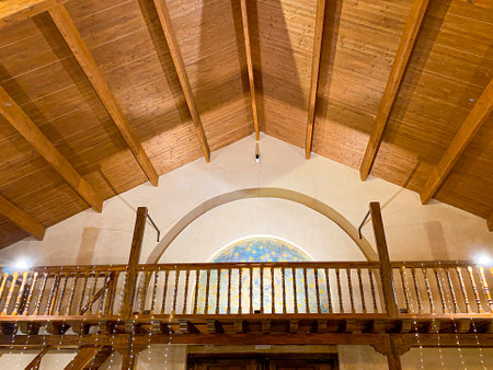 Interior view of a church with arched ceiling and wooden stairsの写真素材