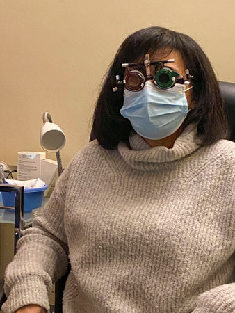 Female patient wearing a mask in a dentist's office in the afternoonの写真素材