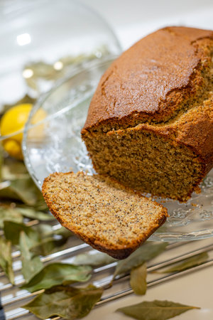Homemade cake with poppy seeds and olive oil on a glass plateの写真素材