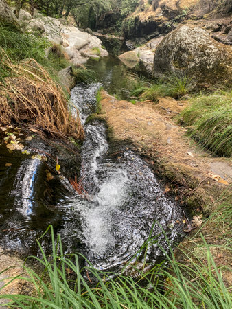 Small waterfall in the forest in the mountains of Andalusia, Spainの写真素材
