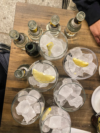 Alcoholic cocktails with ice and lemon on a wooden table.の写真素材