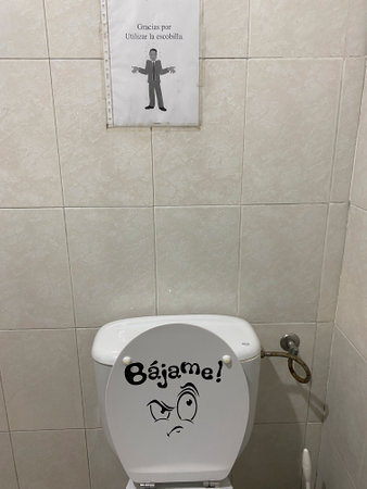 Toilet in a public toilet with a toilet sign saying good morningの写真素材
