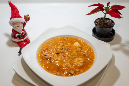 Christmas soup with prawns in a white plate on a white backgroundの写真素材