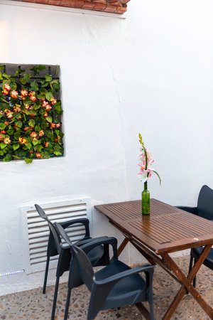 Tables and chairs in a restaurant on a white wall background.の写真素材