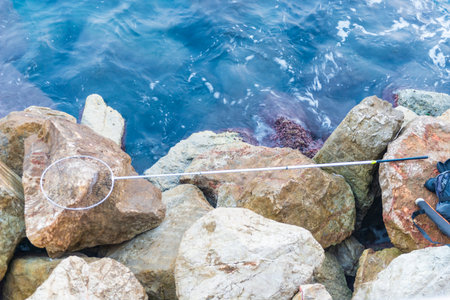 Fishing rod and reel on the shore of the Mediterranean Sea.の写真素材