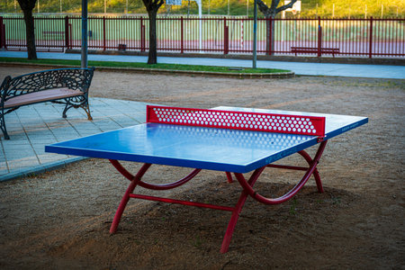 Table tennis table in the park at sunset. Selective focus.