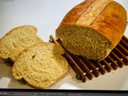Bread and bread knife on a white background, close-up
