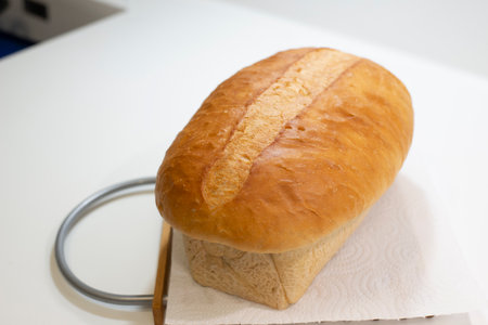 loaf of bread on the table in a bakery shop with a knifeの写真素材