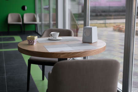 Cup of coffee on the table in an empty caféの写真素材