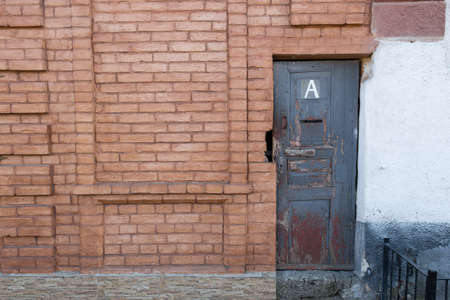 The brick wall with an old doorの写真素材