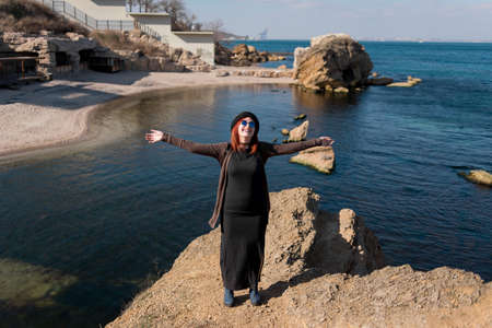 Fun sports girl hands spread on the sides of nature near the oceanの写真素材