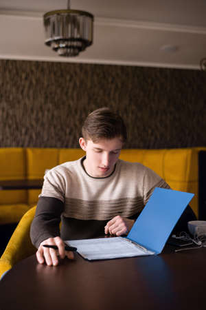 The young guy reads the documentの写真素材