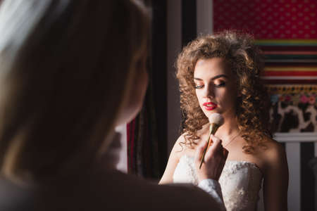 beautiful and young bride doing makeup in the morningの写真素材