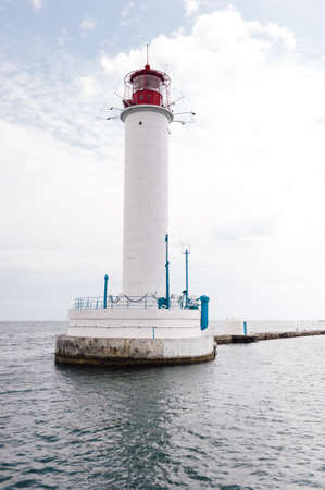 Odessa lighthouse stands on the middle of the sea amidst a white dayの写真素材