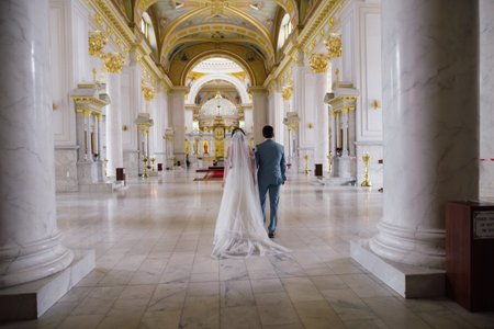 the bride and groom stand in the Orthodox cathedral the wedding ceremony will begin soonのeditorial素材