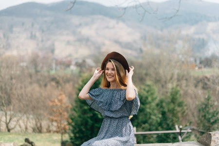 The girl in a hat dreams on the nature