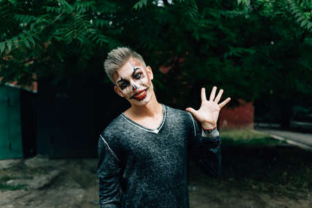 Portrait shot of a scary man wearing traditional sugar skull make-upの写真素材
