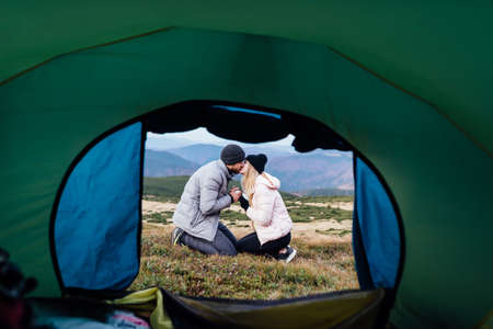kiss of a couple in love on top of a mountains.の写真素材