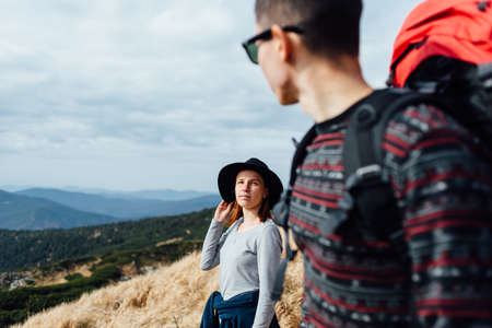Hiking young couple on the mountain hills.の写真素材