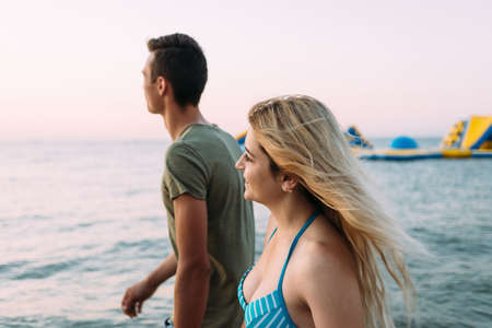 A man and a girl walk by the ocean, breathe the fresh sea airの写真素材