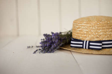 side view on a straw hat lies a fragrant fresh bouquet of lavender. florestic frame.の写真素材