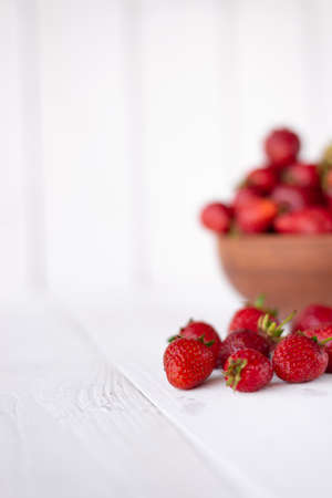 Fresh organic and ripe red strawberries in a macro image. Conceptual images for banners, covers and other design projects. Tasty and juicy berries, place under the textの写真素材