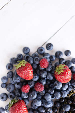 berries strawberries, raspberries, blueberries on a white background view from the top. There is a place under the text. Source of vitamins and miraclesの写真素材
