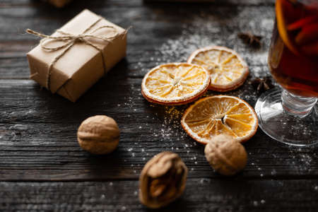 round slices of dry orange lie on a table of wood, a gift in a package. Christmas conceptの写真素材