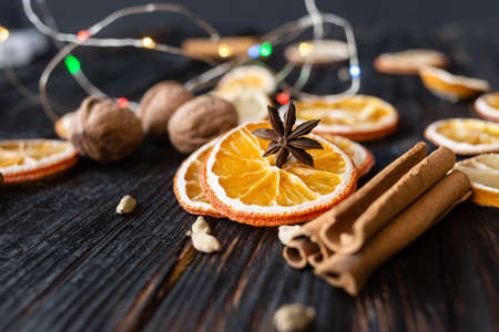 Anise and dried orange slices on a background of woodの写真素材