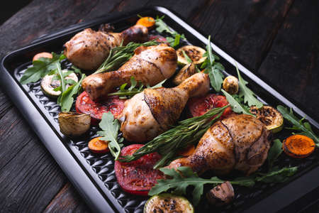 delicious fried chicken legs in a pan, crisp, fast food, grilled vegetables close-up. Gourmet Appetizerの写真素材