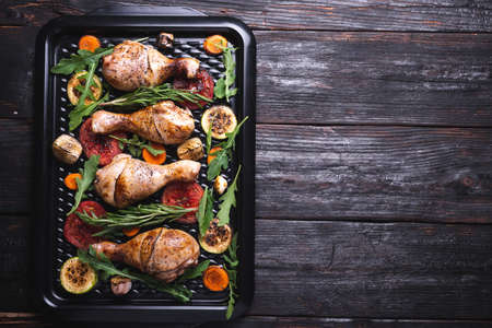 dinner on the table, fried chicken, cooking in the oven, golden brown on meat. Place for text.の写真素材