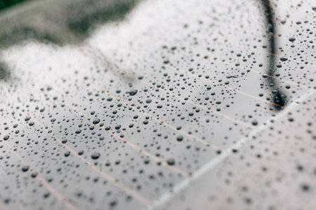Drops of water after heavy rain on a car glass. high humidity