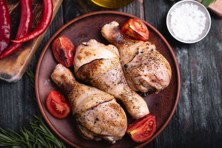 fried chicken drumsticks on a plate, grilled meat, spices and herbs, a delicious dinner recipeの写真素材