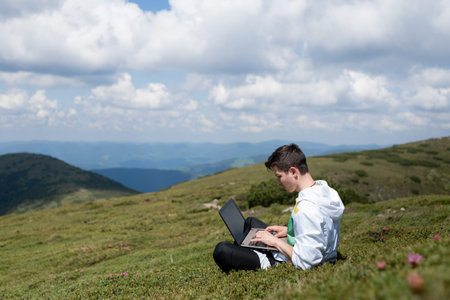 Workaholic man working on laptop during vacation, remote work. Freelancer.