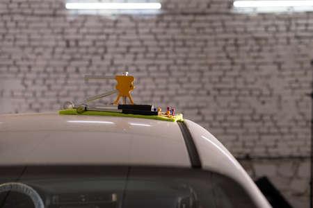 The device for repairing dents lies on the roof of the car on a green rag, close-upの写真素材