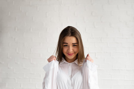 Brunette woman rejoicing her success and victory clenching her fists with joy. Lucky woman being...