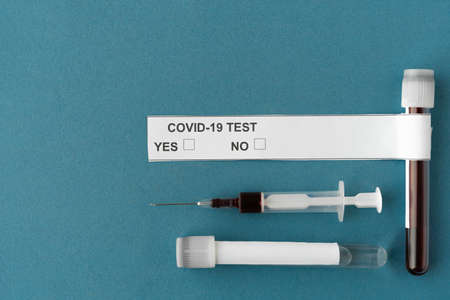analysis for coronavirus, test tube and syringe with blood and covid-19 virus test results. Place for textの写真素材