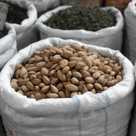 A bag of almonds at the Tbilisi market in Georgia. Unpeeled walnut in the shell. Useful and...