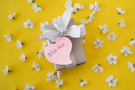 Flowers on a yellow background with a box of gray. Cherry blossoms. Cherry tree flowers on paper...