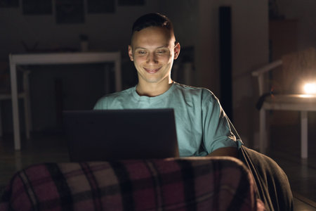 Portrait businessman working at modern loft office at night. Man using a modern laptop.