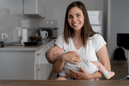 Portrait of happy excited young mother and child girl looking at camera, smiling mom with son making...