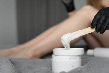 White sugar paste for depilation. Shovel for shugaring. Black latex gloves.
