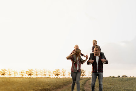happy family on vacation. Mom, dad are two sons. Walk in the fresh air. children are sitting on the...