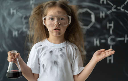 The surprise on the little girl's face. Experiments in a chemistry lesson. Explosion in the laboratory. Mix different liquids. Offline education conceptの写真素材